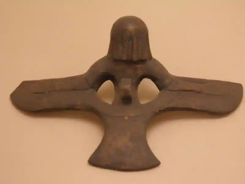 Cauldron handle in a form of a winged man with a solar disc body
